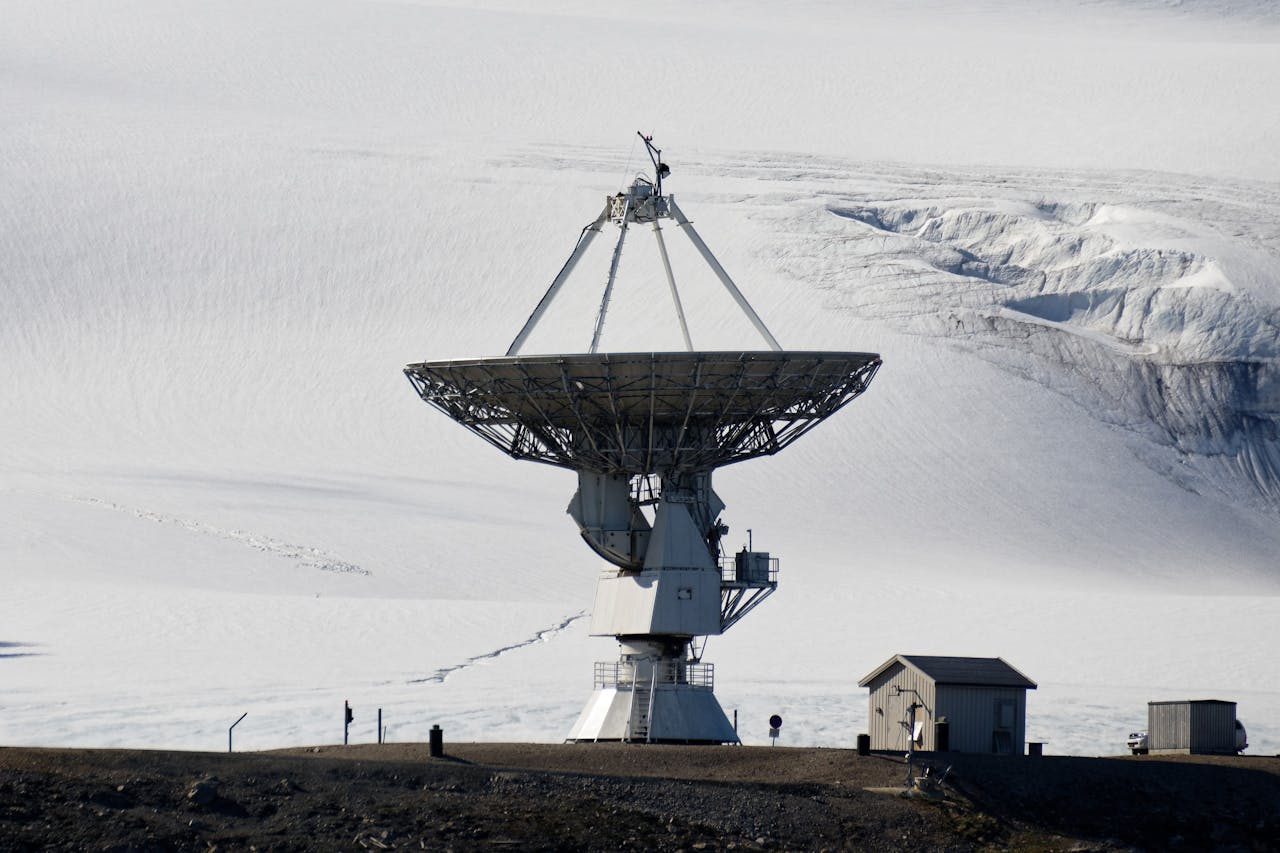 gallery-04 Large satellite dish in a snowy arctic environment for research purposes.